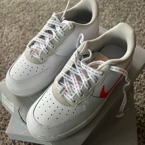Nike White and Gray Sneakers with Orange Swoosh
